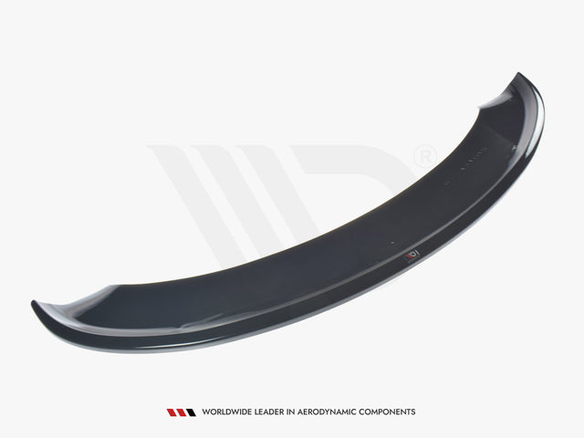 A glossy black car spoiler is displayed against a white background. It curves upwards slightly at each end. Below it, text reads: "WORLDWIDE LEADER IN AERODYNAMIC COMPONENTS."