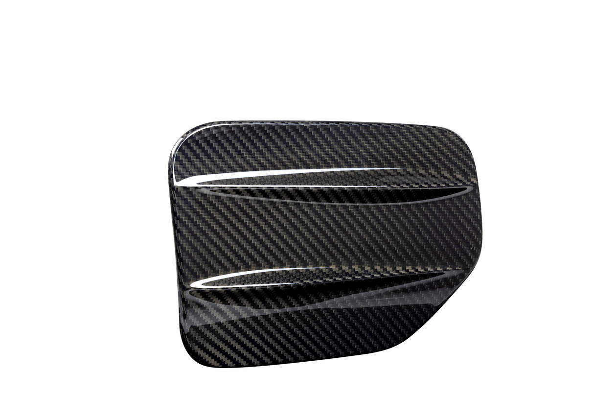 A sleek, carbon fiber car accessory with two aerodynamic ridges, set against a plain white background, showcasing its glossy textured pattern.