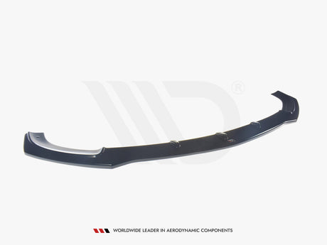 A black aerodynamic car component, resembling a front splitter, rests on a plain white background. Text below reads: "WORLDWIDE LEADER IN AERODYNAMIC COMPONENTS."