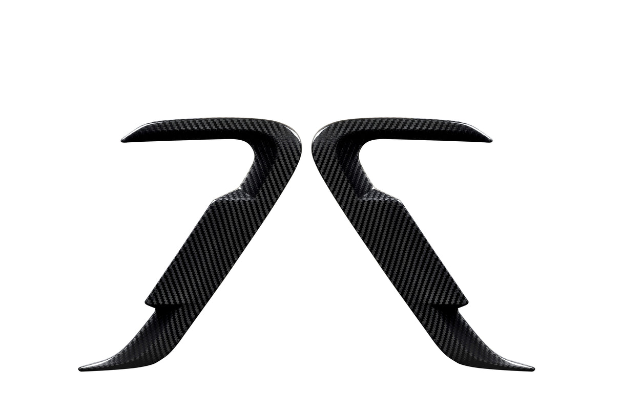 Two carbon fiber car door handles positioned symmetrically, facing each other against a white background, showcasing their sleek, contoured design and smooth texture.