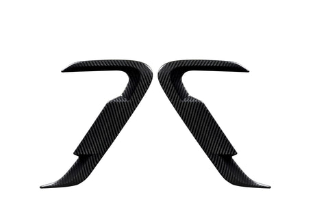 Two carbon fiber car door handles positioned symmetrically, facing each other against a white background, showcasing their sleek, contoured design and smooth texture.