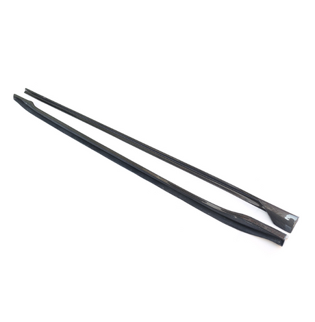 Two long, black carbon fiber strips lie parallel on a white surface, showcasing a sleek, textured appearance suitable for automotive or structural applications.