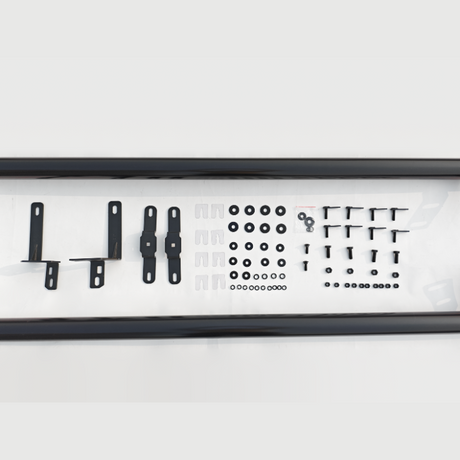 Brackets, bolts, and washers are neatly arranged in rows on a white surface, enclosed by two long, black bars.