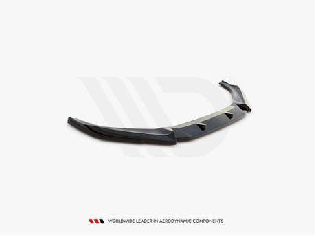 Black car bumper lip sits angled on a white surface. Below, text reads: "WORLDWIDE LEADER IN AERODYNAMIC COMPONENTS."