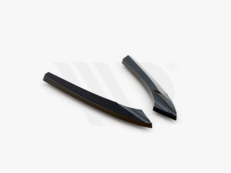Two sleek, black aerodynamic components resting on a white background. They are angled and streamlined in design. Text at the bottom reads: "WORLDWIDE LEADER IN AERODYNAMIC COMPONENTS."