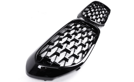 A pair of glossy black honeycomb-patterned car grilles are displayed on a plain white background, showcasing a modern and sleek design intended for automotive use.