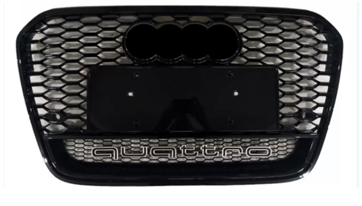 Car grille featuring a honeycomb pattern, with "quattro" text at the bottom. There's a mount for a license plate in the center, and a logo space at the top.