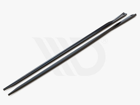 Two sleek, elongated black strips with tapered ends rest side-by-side on a plain gray surface. Text reads, "WORLDWIDE LEADER IN AERODYNAMIC COMPONENTS."