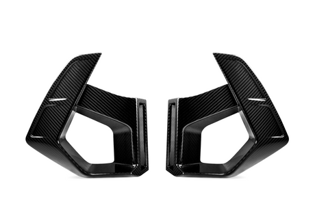 Two carbon fiber vent covers facing each other, featuring sleek, angular designs. They are positioned against a plain white background, highlighting their glossy texture and geometric shapes.