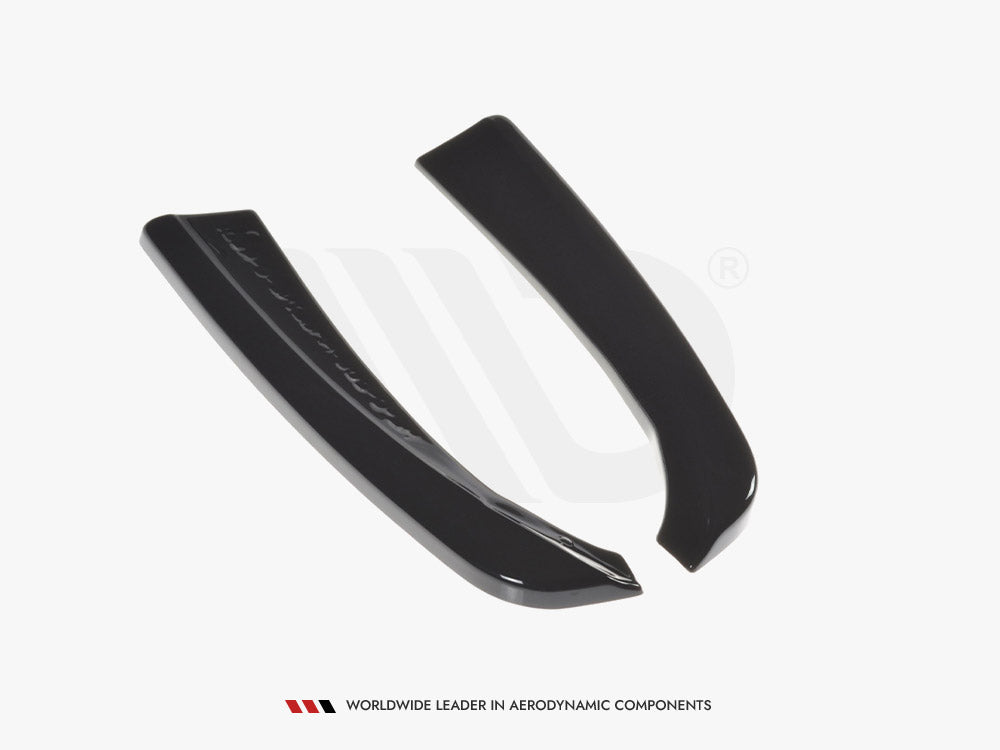 Two sleek, black curved aerodynamic components lie on a white surface. Text below reads: "WORLDWIDE LEADER IN AERODYNAMIC COMPONENTS."