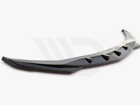 A sleek, black aerodynamic car component with fin-like protrusions rests on a plain white background. Text below reads: "Worldwide leader in aerodynamic components."