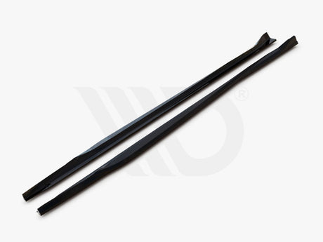 Two long, black aerodynamic components lie parallel on a white surface, with text, "WORLDWIDE LEADER IN AERODYNAMIC COMPONENTS," displayed underneath.