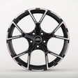 A sleek black alloy wheel with a glossy finish and five split spokes, featuring the Audi logo in the center, displayed against a plain white background.
