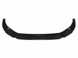 A black car front lip spoiler, featuring an angular, aerodynamic design, lies against a plain white background, emphasizing its sleek structure.