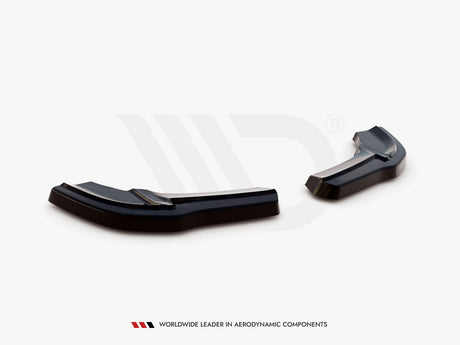 Black aerodynamic car components rest on a white surface in a studio setting. Text below reads: "WORLDWIDE LEADER IN AERODYNAMIC COMPONENTS."