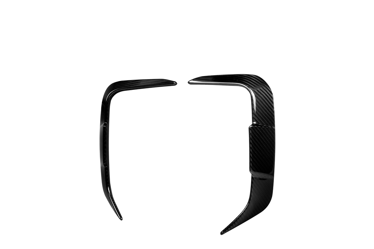 Two sleek black carbon fiber car trim pieces, facing each other symmetrically on a white background, likely designed for enhancing automotive aesthetics.