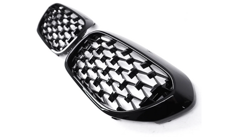 A pair of black, honeycomb-patterned car grille inserts are positioned on a plain white background, showcasing their glossy finish and intricate design.