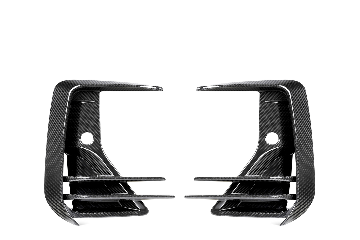 Two carbon fiber air vents, mirror each other, featuring three horizontal slats and a rounded hole in the center against a white background.