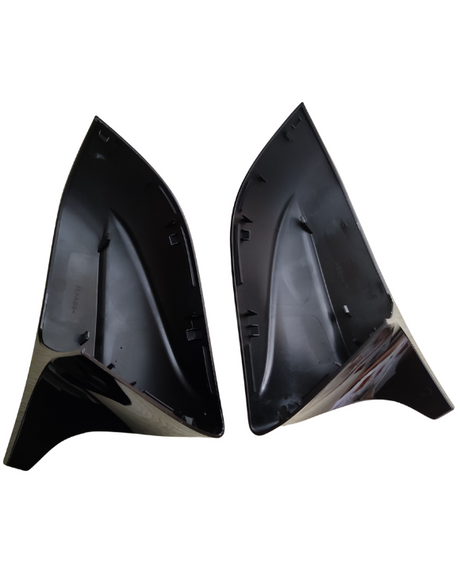 Two black, triangular plastic components face each other, displaying interior grooves and attachment points. Set against a plain white background, they appear clean and unworn, suggesting unused vehicle parts.