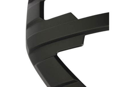 A curved black object with ridges; likely part of a larger structure or machinery component, viewed against a plain white background.