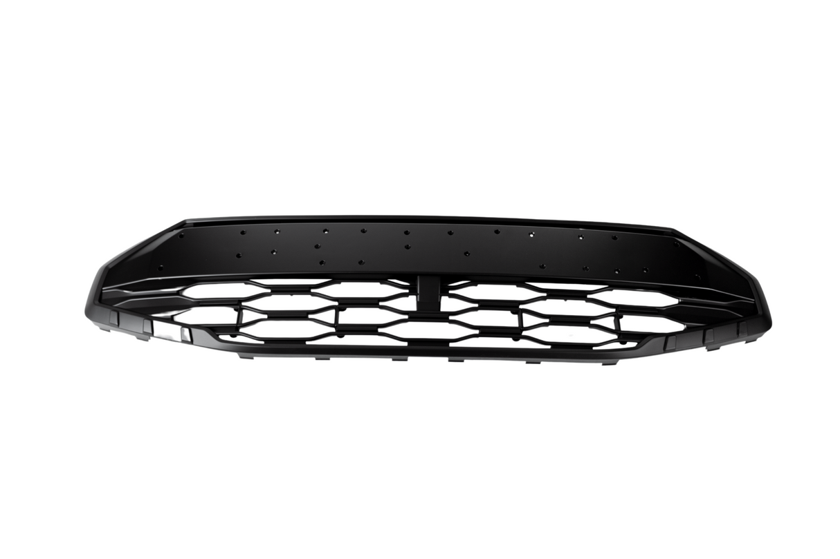 A black car grille with a honeycomb pattern lies stationary against a white background, featuring multiple small holes along the top edge.