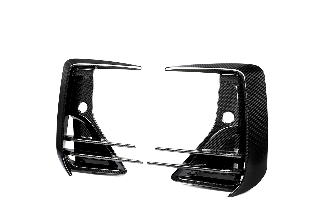 Two carbon fiber car rear diffuser fins with horizontal slats are positioned symmetrically facing each other against a white background, showcasing their sleek, aerodynamic design.