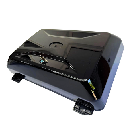 A glossy black hard shell case with a key lock rests on a white surface. It features two latches at the corners and appears reflective.