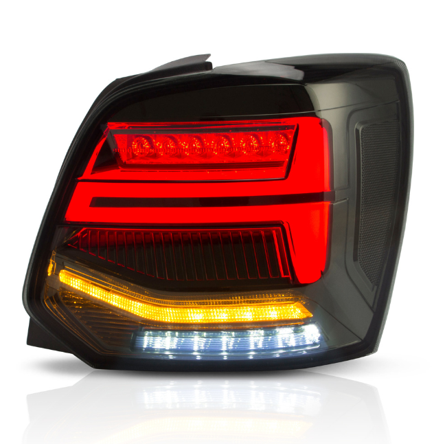 A car taillight assembly displays glowing red, amber, and white LED segments, set against a dark background, highlighting its sleek, modern design with reflective surfaces.