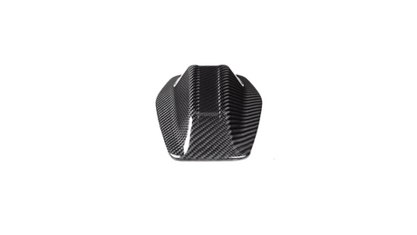 A sleek, black carbon fiber object with a streamlined, angular shape sits against a plain white background, suggesting a component for a vehicle or machinery.