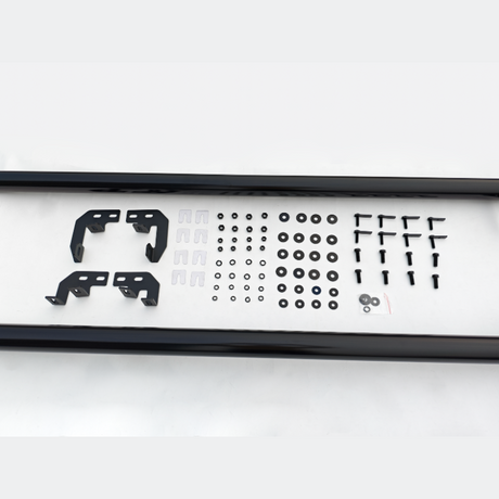 A collection of black metal brackets, screws, and washers is neatly arranged on a white surface, suggesting an assembly kit or hardware package.