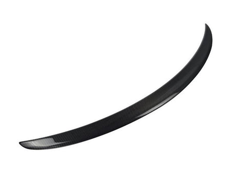 A curved, black carbon fiber car spoiler is displayed, isolated against a plain white background, emphasizing its smooth, aerodynamic design.