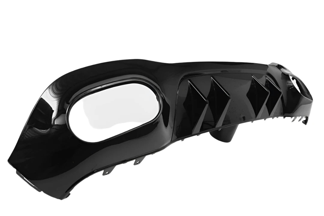 A shiny black car rear diffuser with three vertical fins sits on a white background, featuring an oval exhaust cutout on one end.