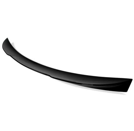 A glossy black car spoiler, slightly arched, is positioned against a plain white background, highlighting its sleek design and aerodynamic purpose.