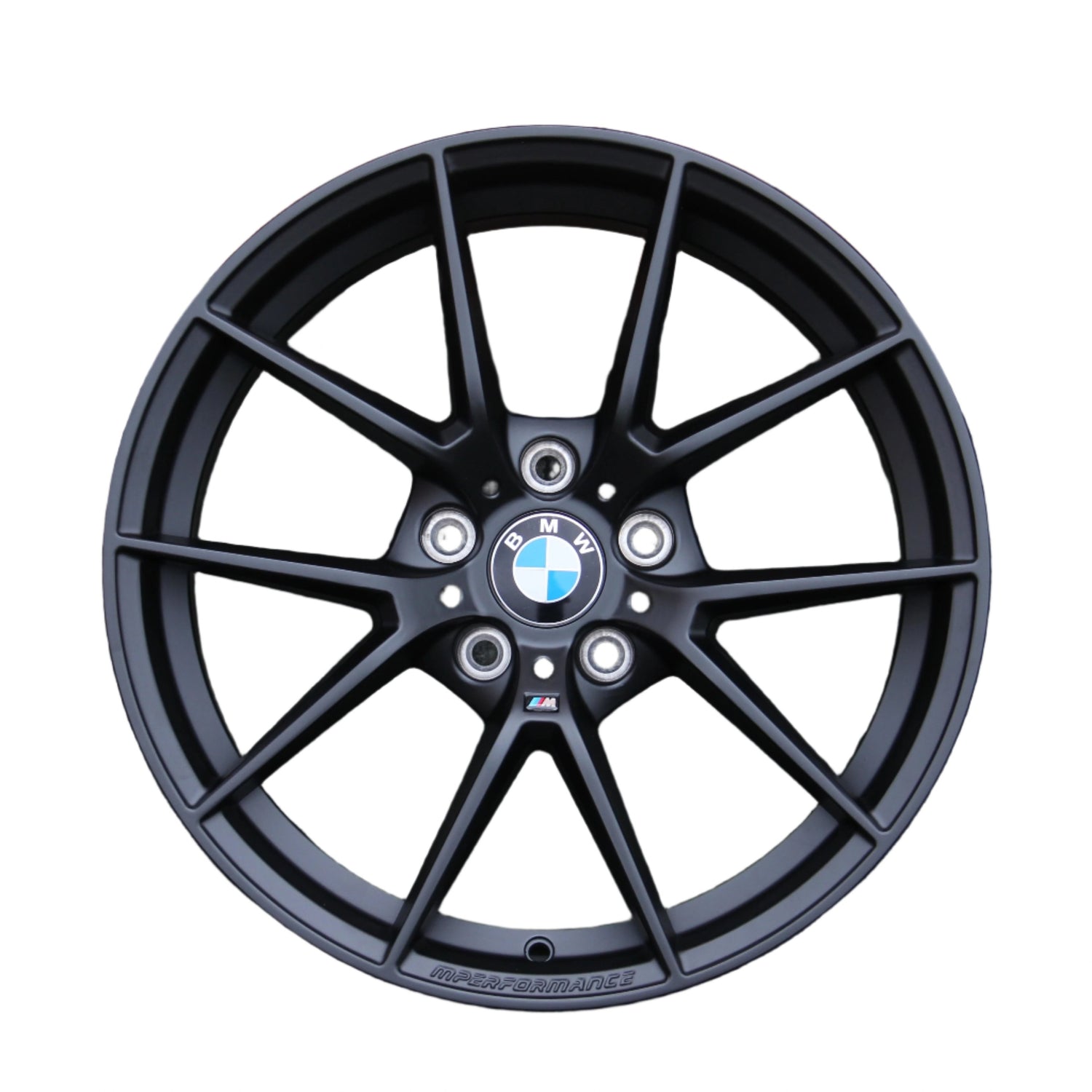A black alloy wheel with a multi-spoke design features a BMW emblem in the center. The text "M PERFORMANCE" is written along the bottom, set against a white background.