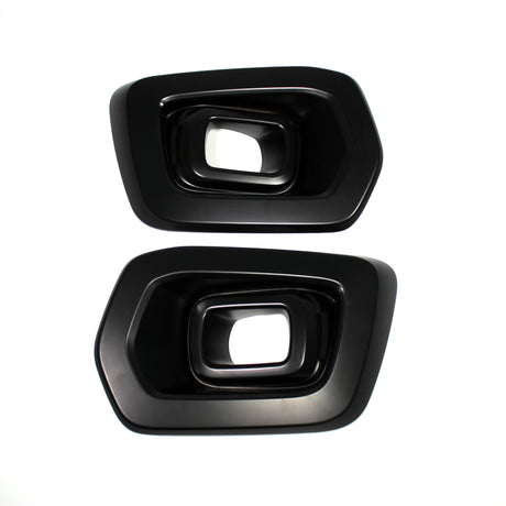 Two black, rectangular exhaust tip covers with beveled edges, placed side by side on a white background, showing their hollow interior.