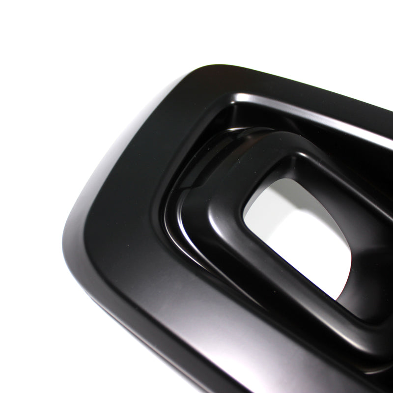 A glossy black, rectangular, hollowed-out object with rounded edges appears against a plain white background, featuring layered, concentric shapes.