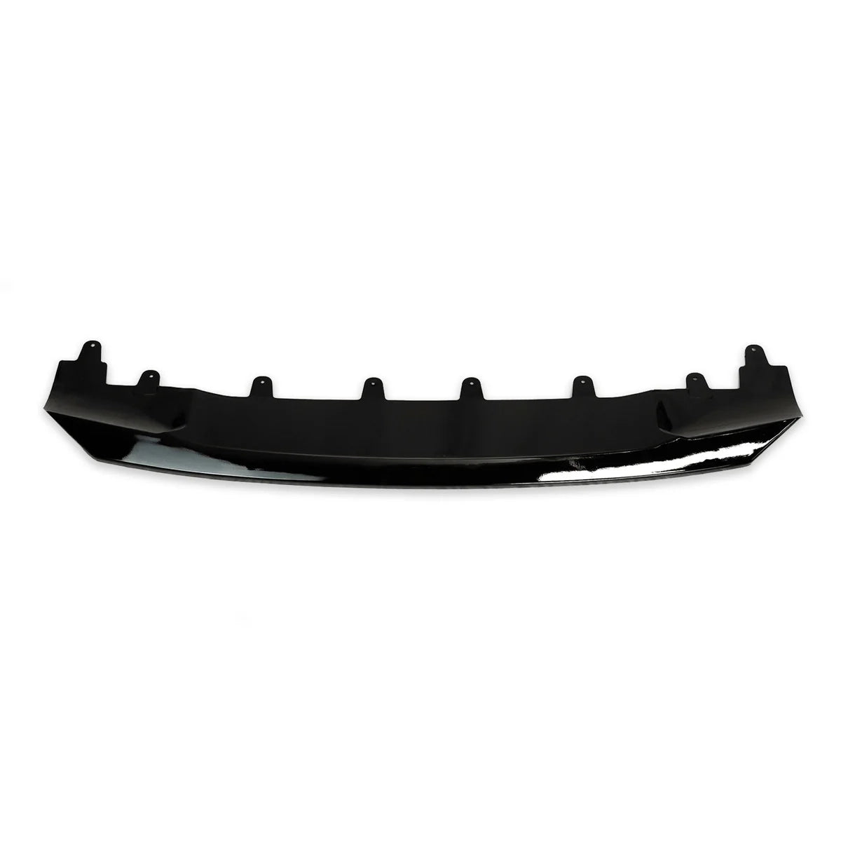 A black car bumper lip lies horizontally, with multiple mounting tabs along its top edge, set against a plain white background.