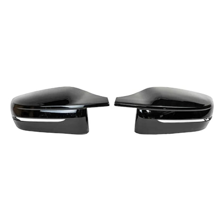 Two black side mirror caps are positioned facing each other on a plain white background. Each has a glossy finish and a silver trim line near the bottom.