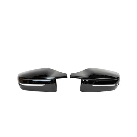 Two glossy black car side mirrors are facing each other, placed against a plain white background, highlighting their sleek design and reflective surfaces.