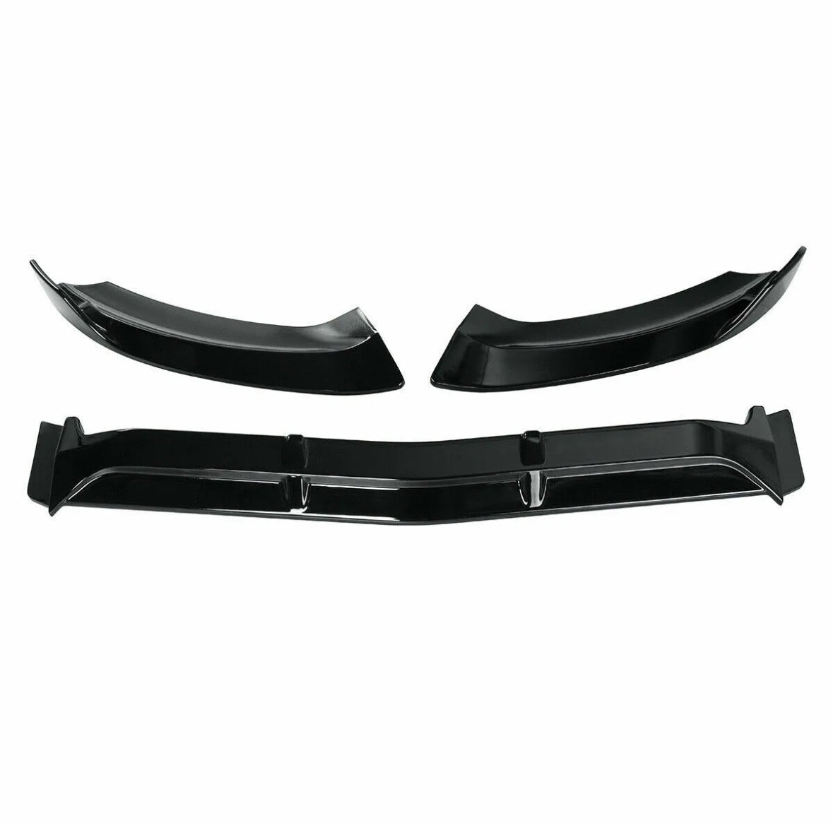 Three black car bumper splitters are displayed; two are curved, and one is long and straight, with fins. They rest against a plain white background, suggesting an auto accessory context.