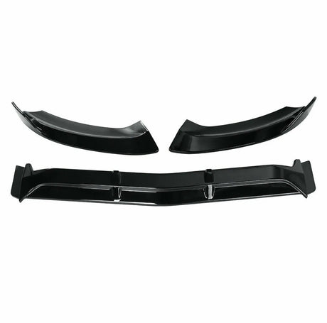 Three black car bumper splitters are displayed; two are curved, and one is long and straight, with fins. They rest against a plain white background, suggesting an auto accessory context.