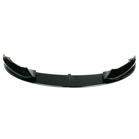A glossy black car spoiler is positioned horizontally, displaying its sleek, curved design. It is set against a plain white background, emphasizing its aerodynamic shape.