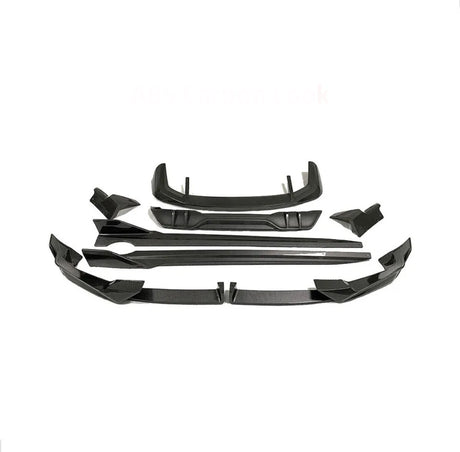 Car body kit parts arranged on a white background, featuring multiple angular black pieces designed for aerodynamic enhancement. Text reads "ABS Carbon Look."