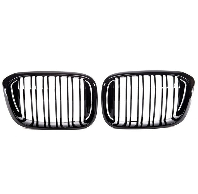 Two sleek, black car grilles with vertical slats are positioned side by side against a white background, suggesting a symmetrical, possibly automotive design focus.