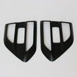 Two black, angular car air vent covers with rectangular openings positioned side by side on a white background.