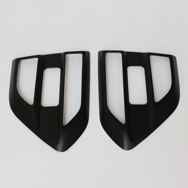 Two black, angular car air vent covers with rectangular openings positioned side by side on a white background.