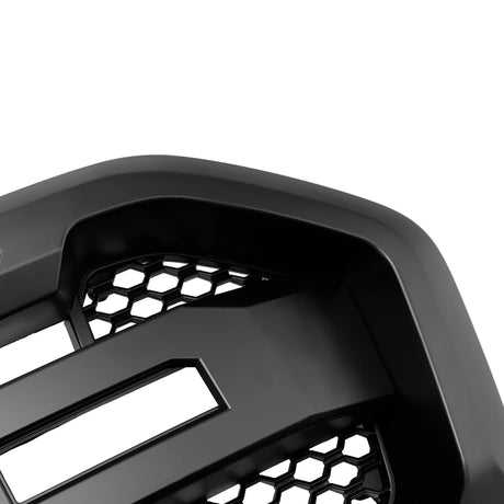 A black, angular car grille featuring a hexagonal mesh pattern, viewed close-up against a plain white background.