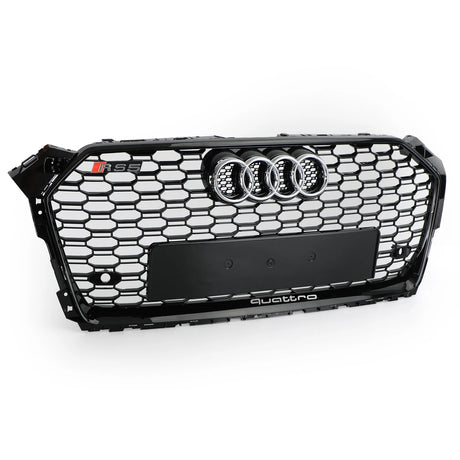 A black Audi car grille with a honeycomb pattern features a chrome Audi emblem, "RS5" badge, and the word "quattro" at the bottom, displayed against a plain white background.
