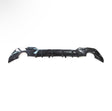A black car bumper is laid against a plain white background, showcasing its aerodynamic design with curved edges and integrated vent-like features.