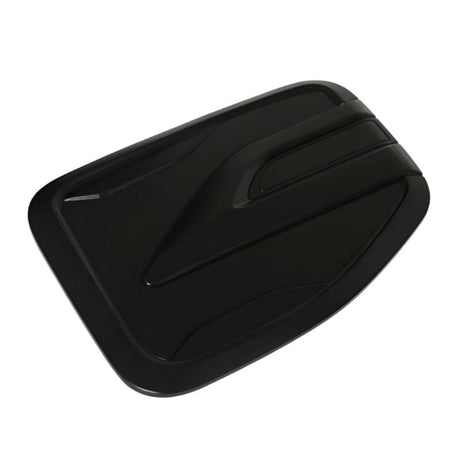 Rectangular black object with angled, aerodynamic grooves across its surface, resembling a vent cover. It rests on a flat white background.